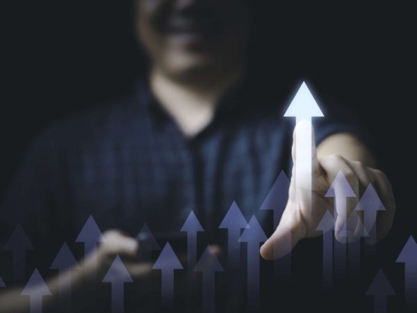 businessman-touching-glowing-increasing-arrow-business-profit-investment-growth-concept-1-scaled